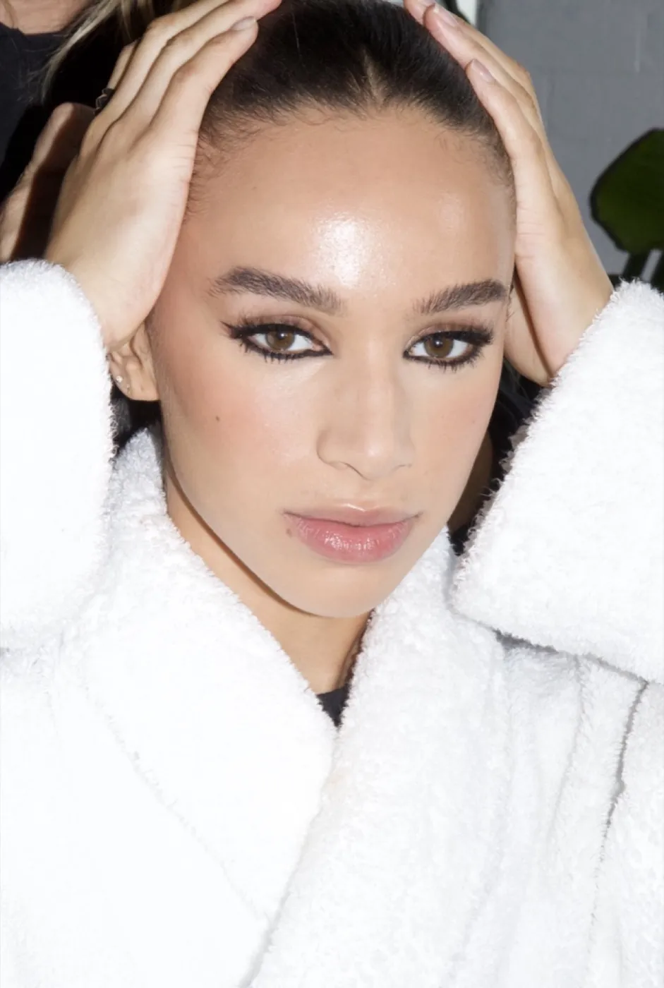 Editorial portrait with graphic liner in a white robe
