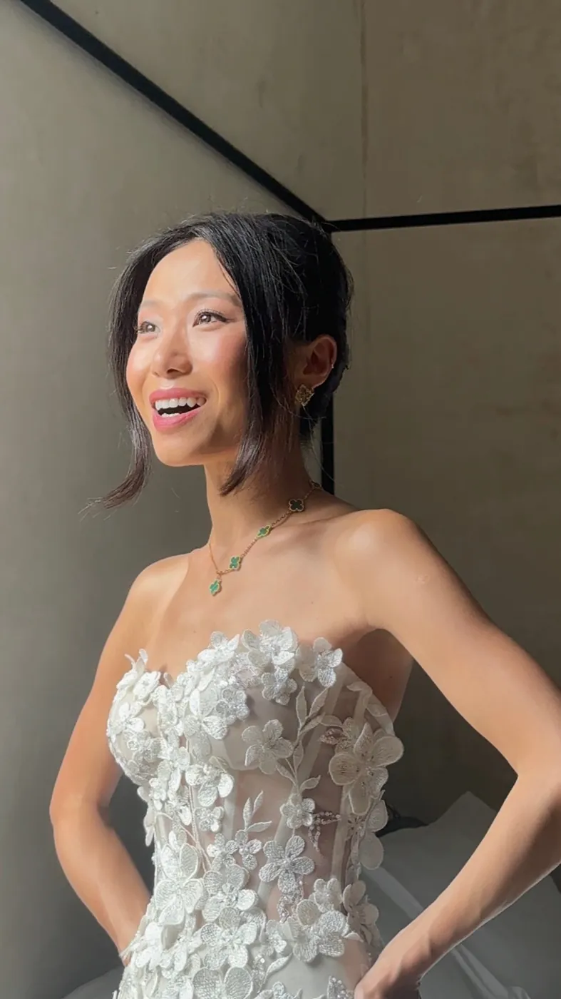 Connie laughing in a floral strapless gown and Van Cleef necklace