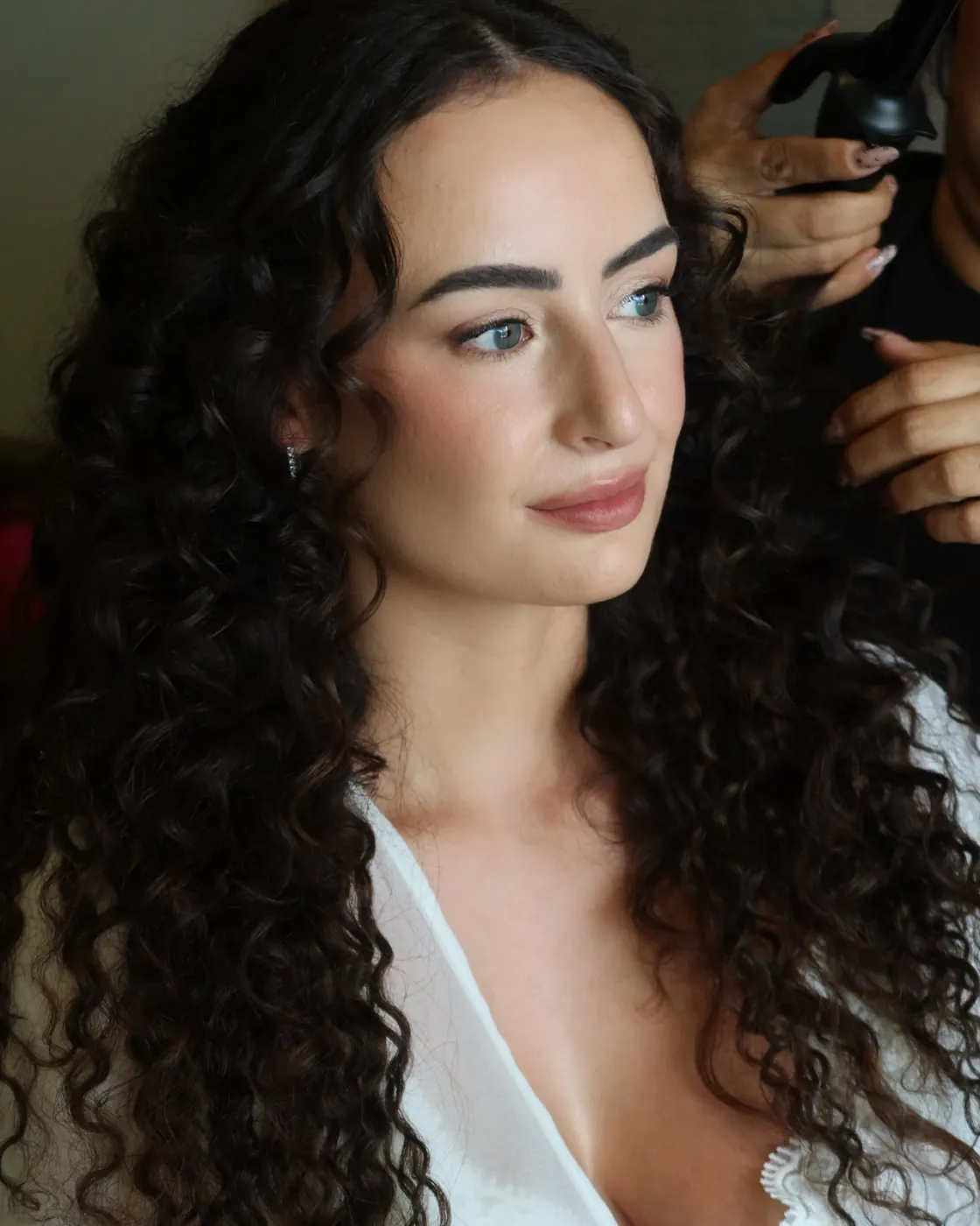 Bride with defined curls and soft, glowing skin
