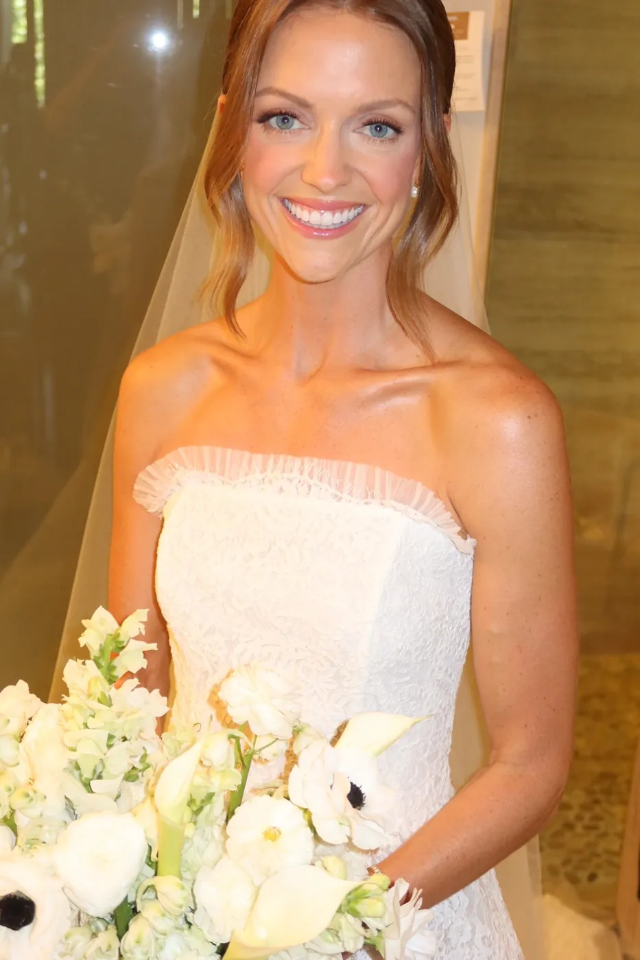 Smiling bride holding a white bouquet