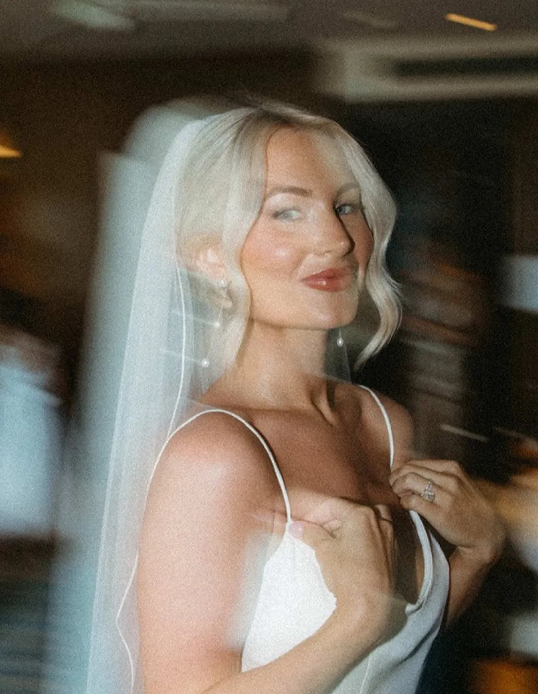 Blonde bride turning in a cathedral veil, soft luminous skin