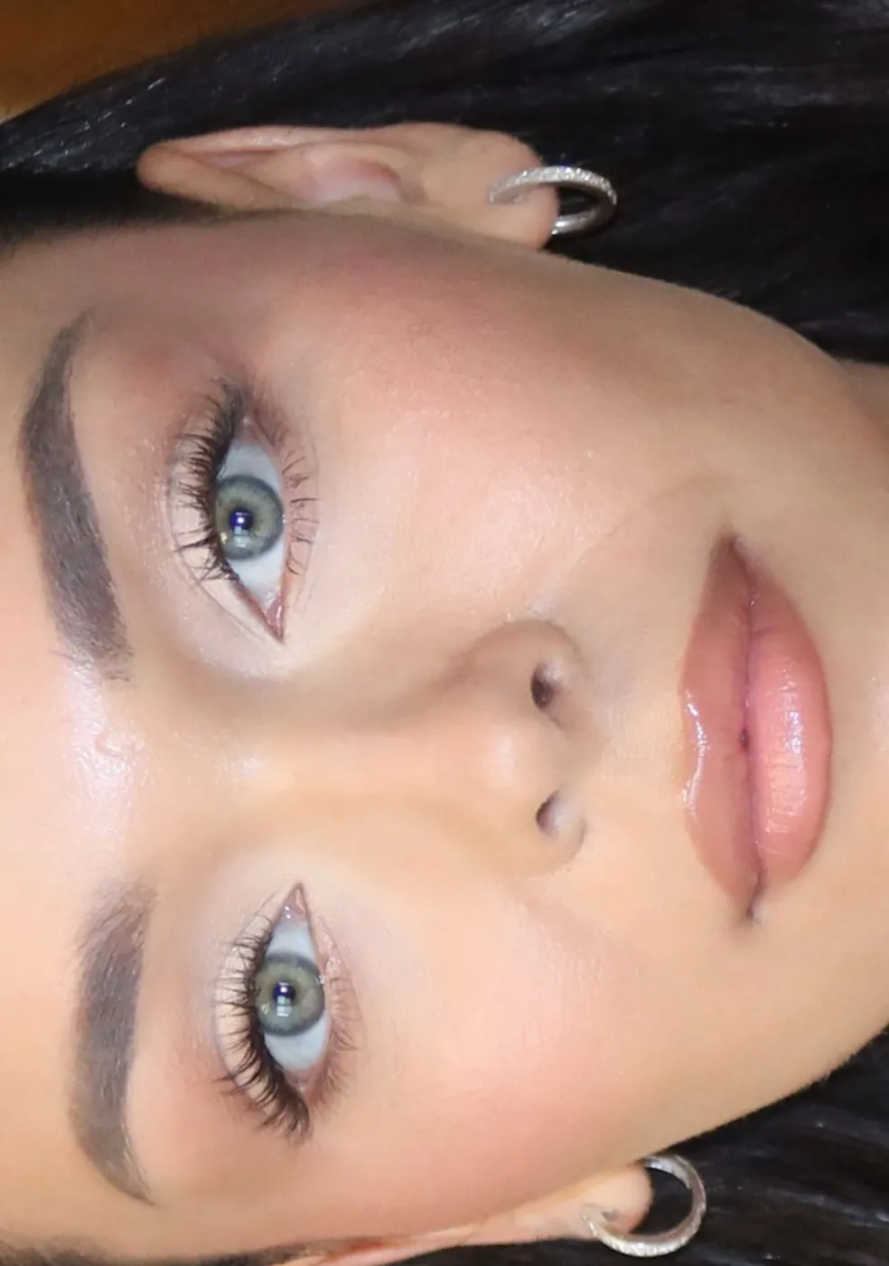 Upside-down close-up of a blue eye and fluttery lashes
