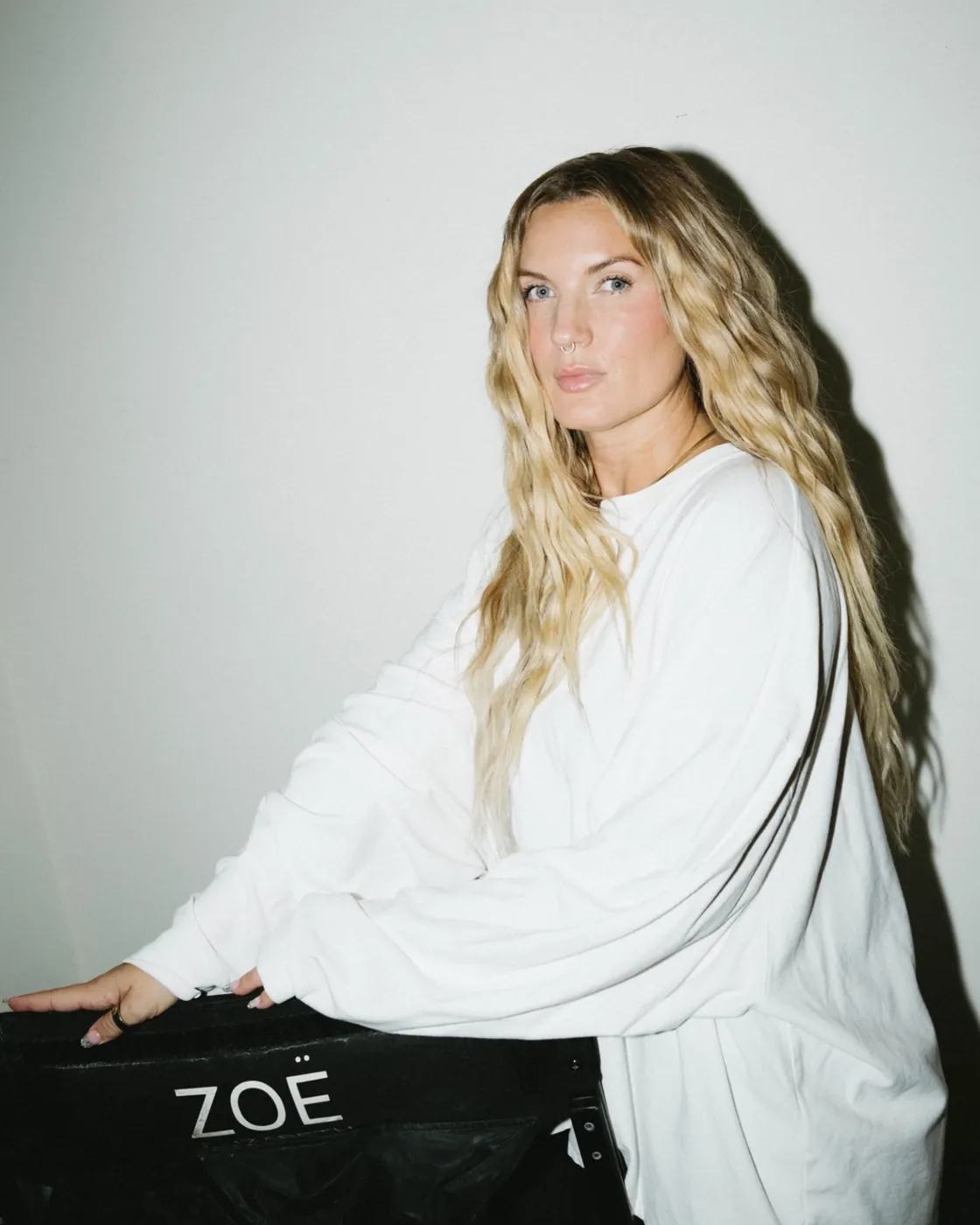 Zoë Elizabeth seated at her director&rsquo;s chair in a white sweatshirt